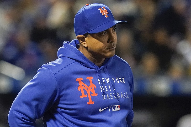 New York Mets manager Luis Rojas checks on Jeff McNeil after McNeil was hit by a pitch during the fourth inning of a baseball game against the Miami Marlins, Thursday, Sept. 30, 2021, in New York. (AP Photo/Frank Franklin II)