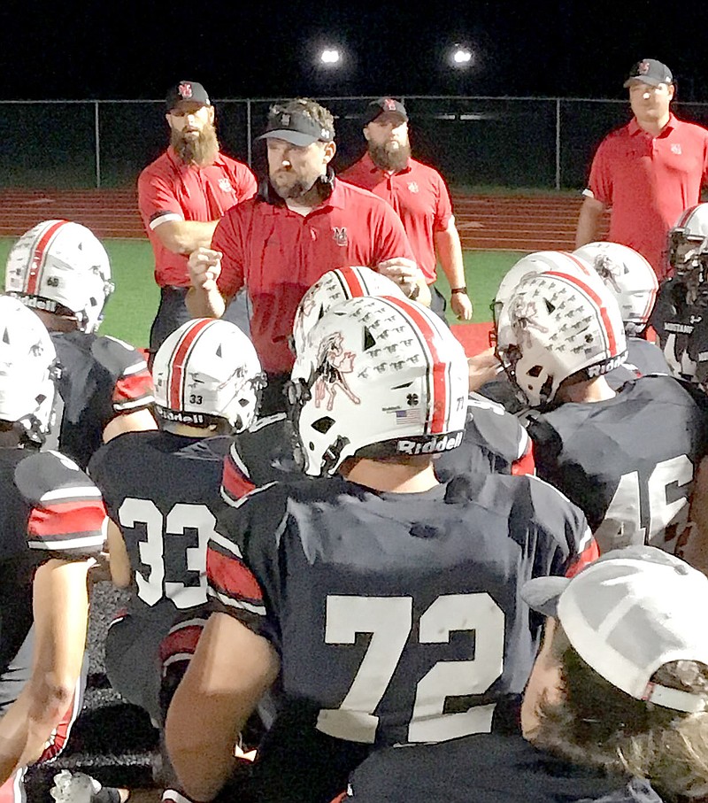 Al Gaspeny/Special to McDonald County Press
McDonald County coach Kellen Hoover addresses the team after the 35-13 victory over East Newton at Mustang Stadium.