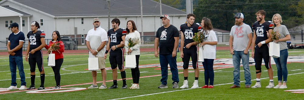 Al Gaspeny/Special to McDonald County Press
Jared Mora (32), Cole Martin (12), Levi Malone (80) and Logan Harriman were some of the seniors and their families who were honored Friday night at Mustang Stadium.