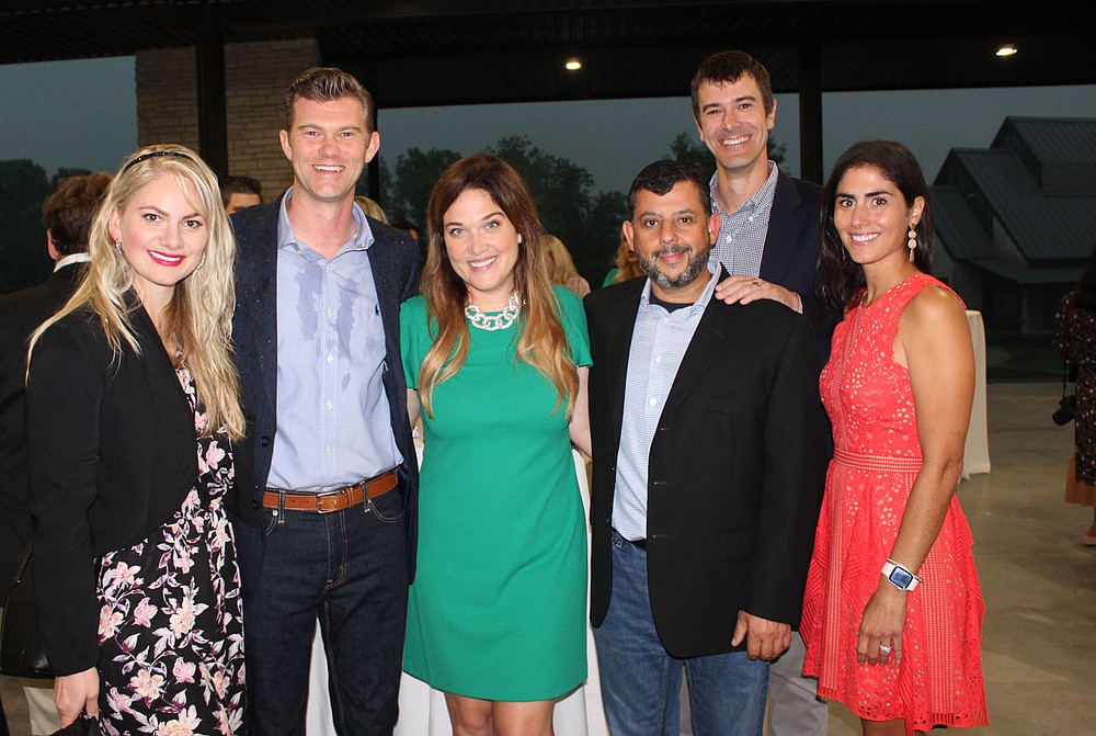 Alisha and Dan Keefer (from left), Jessica and Jamie Willis and Rob and Jen Gelbach gather at the Big Event.
(NWA Democrat-Gazette/Carin Schoppmeyer)