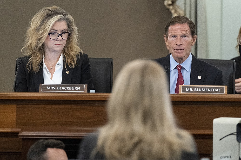 Sen. Marsha Blackburn, R-Tenn., left, and Sen. Richard Blumenthal, D-Conn., right speak to former Facebook data scientist Frances Haugen, center, during a hearing of the Senate Commerce, Science, and Transportation Subcommittee on Consumer Protection, Product Safety, and Data Security, on Capitol Hill, Tuesday, Oct. 5, 2021, in Washington. (AP Photo/Alex Brandon)