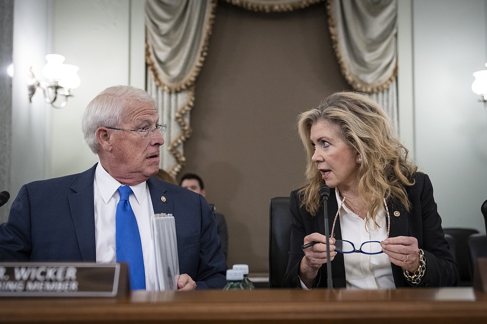 Sen. Roger Wicker, R-Miss., and ranking member Sen. Marsha Blackburn, R-Tenn., talk before a Senate Committee on Commerce, Science, and Transportation hearing on Capitol Hill on Tuesday, Oct. 5, 2021, in Washington. (Drew Angerer/Pool via AP)