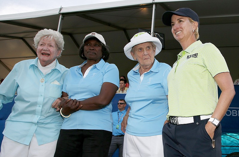 FILE - Karrie Webb, right, of Australia, poses with LPGA Founder Marilynn Smith, left, LPGA &quot;Pioneer&quot; Renee Powell, second from left, and LPGA Founder Shirley Spork, second from right, as Webb arrives for ceremonies after winning the LPGA Founders Cup golf tournament in Phoenix, in this Sunday, March 23, 2014, file photo. The tournament now is sponsored by New Jersey-based Cognizant, which chose to invest in men's and women's golf. (AP Photo/Ross D. Franklin, File)