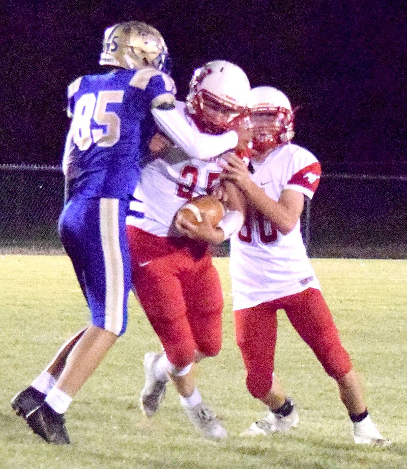 Westside Eagle Observer/MIKE ECKELS
Bulldog Edger Herrera (85) latches onto the quarterback and eventually brought him down during the Decatur-Midland eight-man football contest in Decatur Sept. 24. The Decatur varsity football team was off Oct. 8 but returns to Bulldog Stadium Oct. 15 to face Brinkley in another eight-man conference contest.