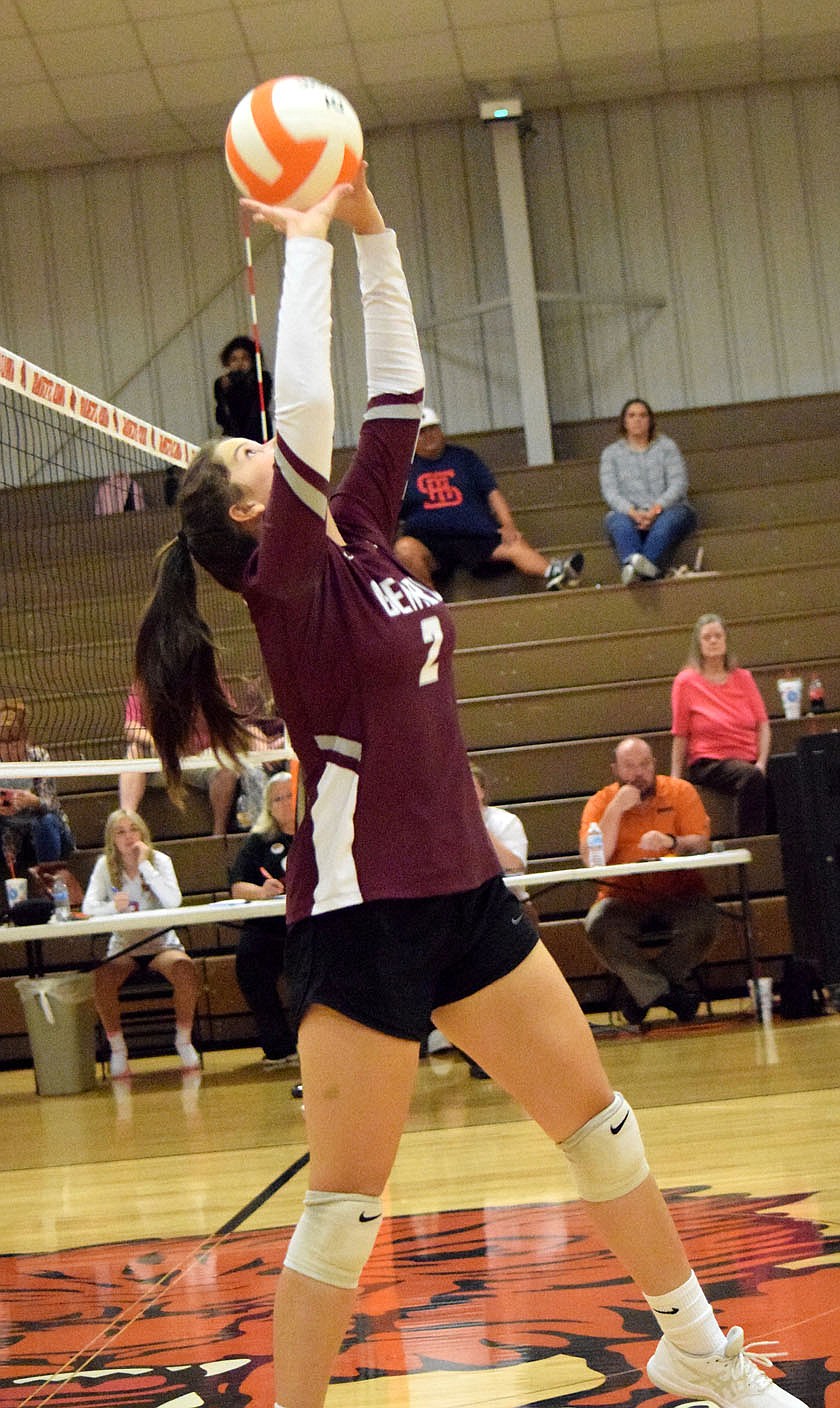 Westside Eagle Observer?MIKE ECKELS
Lady Pioneer Reese Hester uses both hands to power the ball back over her head and into the Lady Lion side of the court during the Thursday night Gravette-Gentry varsity volleyball match in Gravette. In its final 2021 appearance in the Competition Gym in Gravette, the Lady Lions claimed the three set victory over the Lady Pioneers.