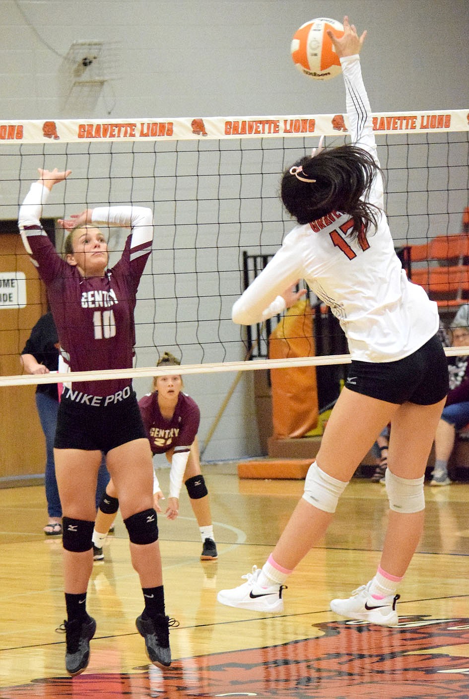 Westside Eagle Observer/MIKE ECKELS
Madison Voyles (Gentry 10) goes up in anticipation of a hit by Lady Lion Ella Pinches (17) during the third set of the Gravette-Gentry conference volleyball contest at the Competition Gym in Gravette Thursday night. Pinches managed to hit the ball past Voyles for a Lady Lion point.