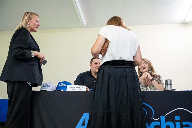 A job seeker speaks with recruiters from Appalachian Wireless during a job fair at a community center in Beattyville, Ky., on July 28, 2021. MUST CREDIT: Bloomberg photo by Jon Cherry.