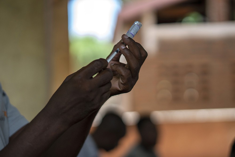 FILE - In this file photo taken Wednesday, Dec. 11, 2019, health officials prepare to vaccine residents of the Malawi village of Tomali, where young children become test subjects for the world's first vaccine against malaria. The World Health Organization recommended that the world’s first malaria vaccine be given to children across Africa, in a move officials hope will spur the stalled progress against efforts to curb the spread of the parasitic disease. (AP Photo/Jerome Delay, File)