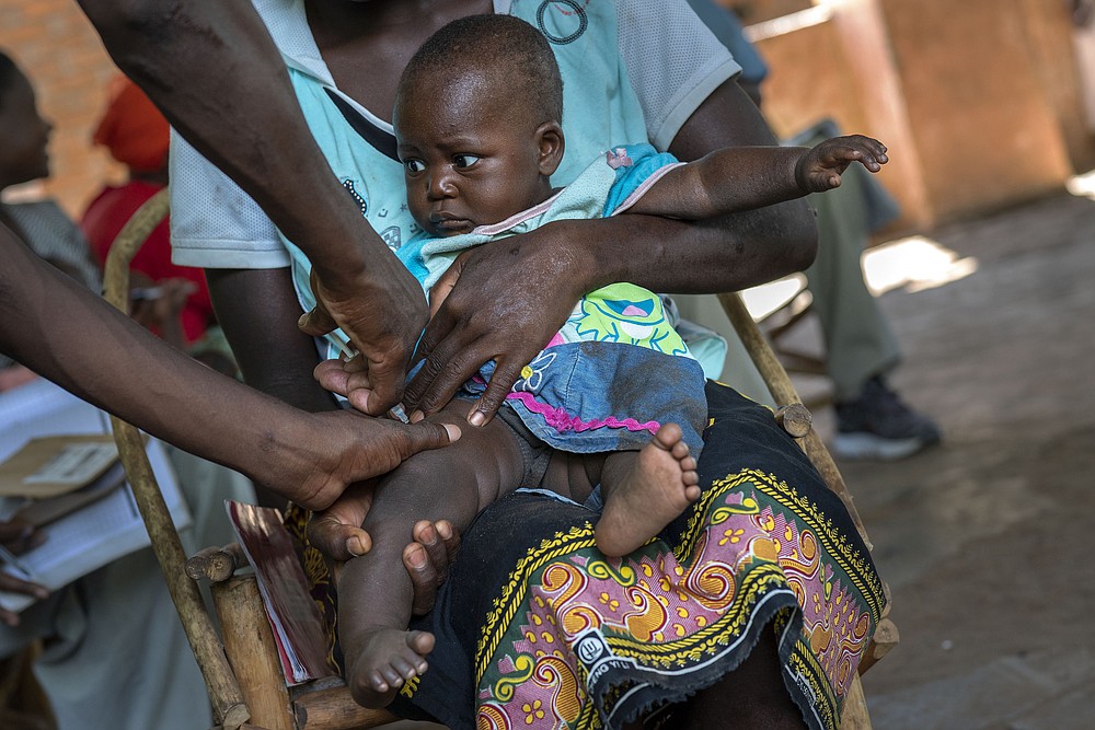 FILE - In this Wednesday, Dec. 11, 2019 file photo, a baby from the Malawi village of Tomali is injected with the world's first vaccine against malaria in a pilot program. The world’s first malaria vaccine should be given to children across Africa, the World Health Organization recommended Wednesday Oct. 6, 2021, a move that officials hope will spur stalled efforts to curb the spread of the parasitic disease. (AP Photo/Jerome Delay, file)