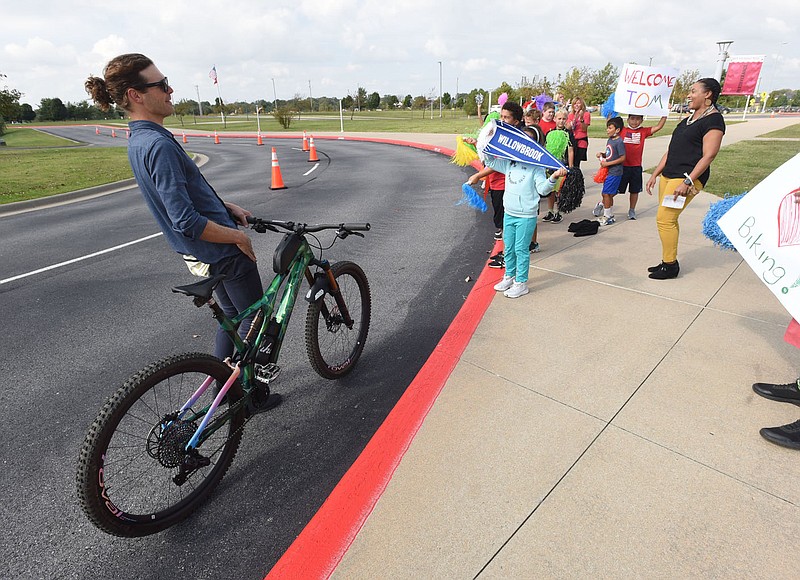 SCHOOL BIKING CHAMPIONS
Students and faculty at Willowbrook Elementary in Bentonville, including Principal Christina Hamilton (right), greet Tom Walton, co-founder of the Runway Group, who delivered by bicycle a $5,000 grant to the school. Willowbrook won the &quot;Bike Bentonville Schools&quot; challenge, a contest in the Bentonville School District during September to encourage students to ride their bikes to school. Willowbrook won the prize by increasing bike ridership among students by 77 percent during September. Eighteen schools took part in the contest and each school that raised student biking percentage received $2,500. The contest was a partnership of the Runway Group and Bentonville schools, with philanthropic support from Tom and Steuart Walton. OZ Trails donated 20 bike racks to Willowbrook and principal Hamilton plans to buy more with the grant money. Go to nwaonline.com/211007Daily/ to see more photos. 
(NWA Democrat-Gazette/Flip Putthoff)