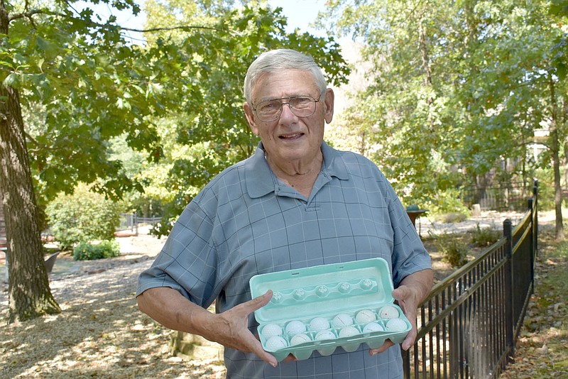 Rachel Dickerson/The Weekly Vista John Justice of Bella Vista sells found golf balls at a discount at his home on Dogwood Golf Course with proceeds going to charity. He sells them by the dozen.