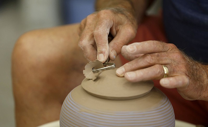 Blanchard Reel trims a lid to fit Tuesday, July 27, 2021, for a pot he spun in the Wheel Room during Open Studio time available at the Community Creative Center in Fayetteville. The center is announcing the free Arvest Senior Series for seniors ages 62 and up taking place in September and October at the center. More information can be found at communitycreativecenter.org. Check out nwaonline.com/210728Daily/ and nwadg.com/photos for a photo gallery.(NWA Democrat-Gazette/David Gottschalk)