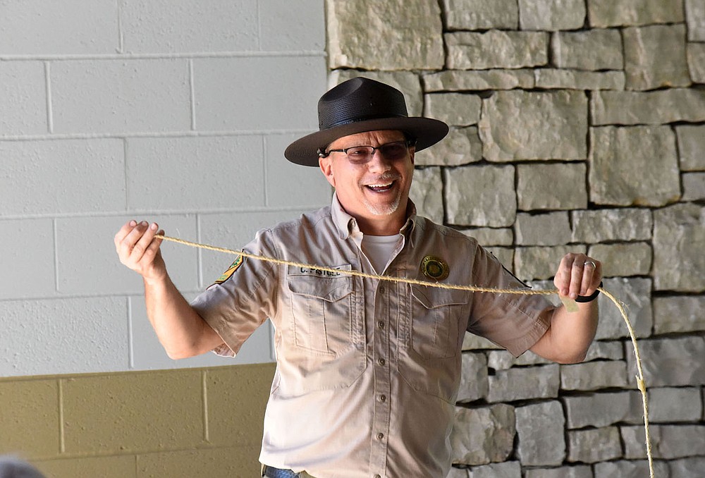 Chris Pistole, park interpreter at Hobbs State Park-Conservation Area, uses a rope to show the wingspan of different birds. (NWA Democrat-Gazette / Flip Putthoff)