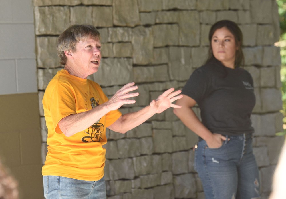 Lynn Sciumbato, a longtime federally licensed wildlife rehabilitator, talks about the treatment of the bald eagle she released in the Hobbs State Park Conservation Area. Madison Kennedy (right) of Northsong Wild Bird Rehabilitation hears his remarks. (NWA Democrat-Gazette / Flip Putthoff)
