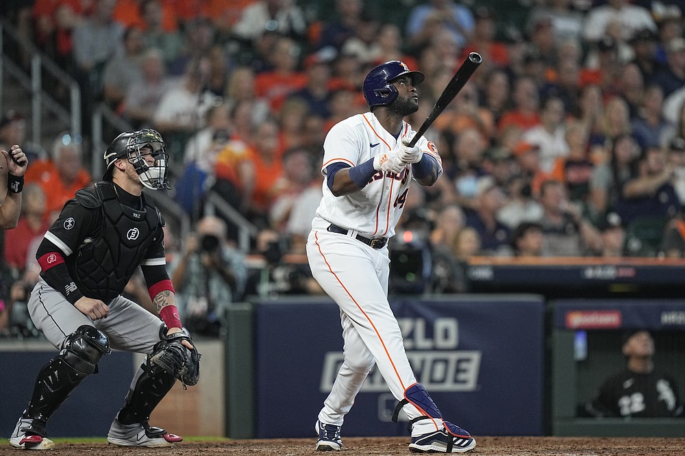 Houston Astros designated hitter Yordan Alvarez watches his ball as he hits a solo home run off Chicago White Sox relief pitcher Reynaldo Lopez during the fifth inning in Game 1 of a baseball American League Division Series Thursday, Oct. 7, 2021, in Houston. White Sox catcher Yasmani Grandal watches the ball as well. (AP Photo/David J. Phillip)