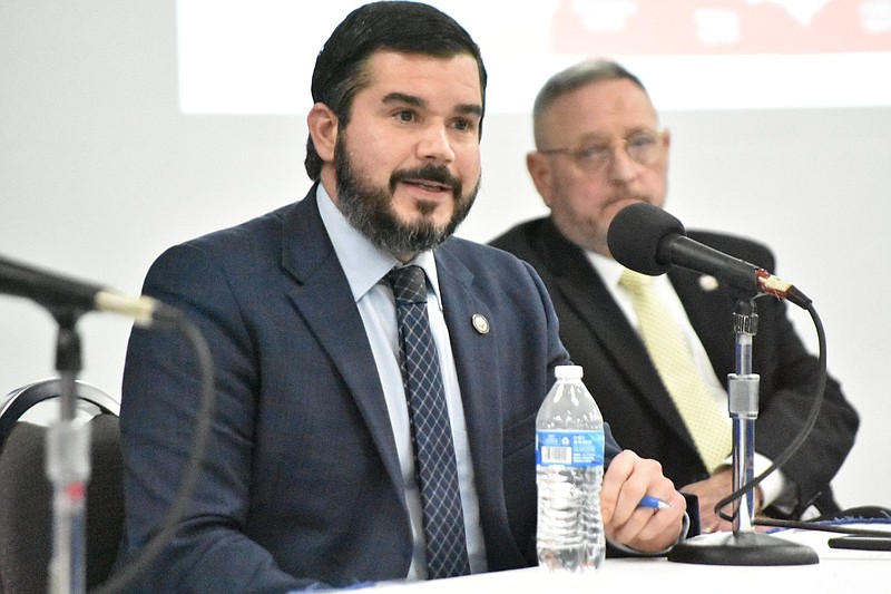 Brad Nye, legislative director for the office of Arkansas Attorney General Leslie Rutledge, fields a question as Deputy Attorney General Douglas House listens in the background Thursday at the Pine Bluff Convention Center. (Pine Bluff Commercial/I.C. Murrell)