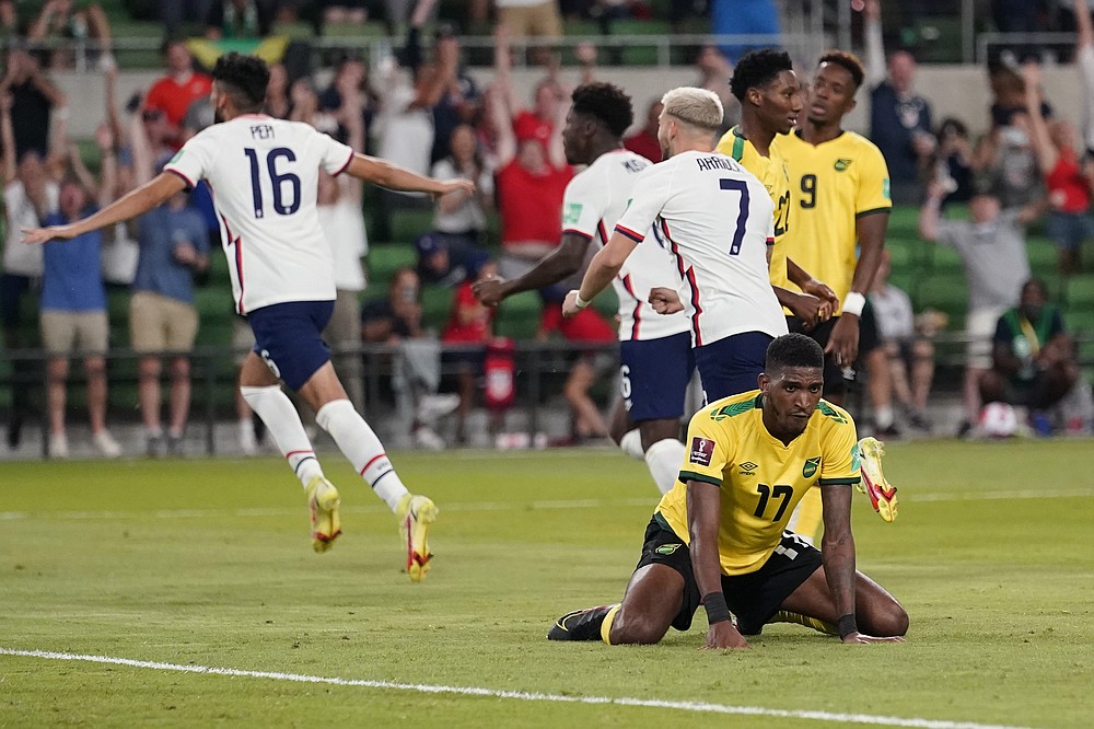 Jamaica's Damion Lowe (17) reacts as the United States celebrates a goal during a FIFA World Cup qualifying soccer match Thursday, Oct. 7, 2021, in Austin, Texas. (AP Photo/Eric Gay)