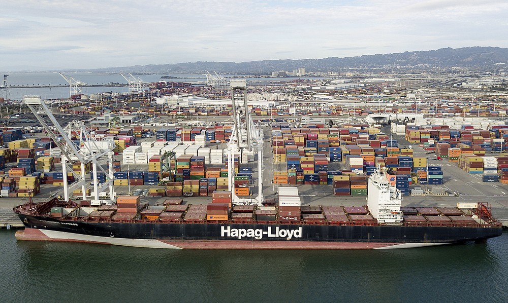 The Rotterdam Express is seen at the Port of Oakland, Wednesday, Oct. 6, 2021 in Oakland, Calif. The Rotterdam Express, a massive cargo ship made a series of unusual movements while anchored in the closest spot to a Southern California oil pipeline that ruptured and sent crude washing up on beaches, according to data collected by a marine navigation service. (AP Photo/Josh Edelson)