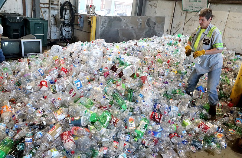 Cedar Glades Landfill employee Shelly Edwards sorts plastic the city of Hot Springs dropped off Tuesday at the landfill. - Photo by Richard Rasmussen of The Sentinel-Record