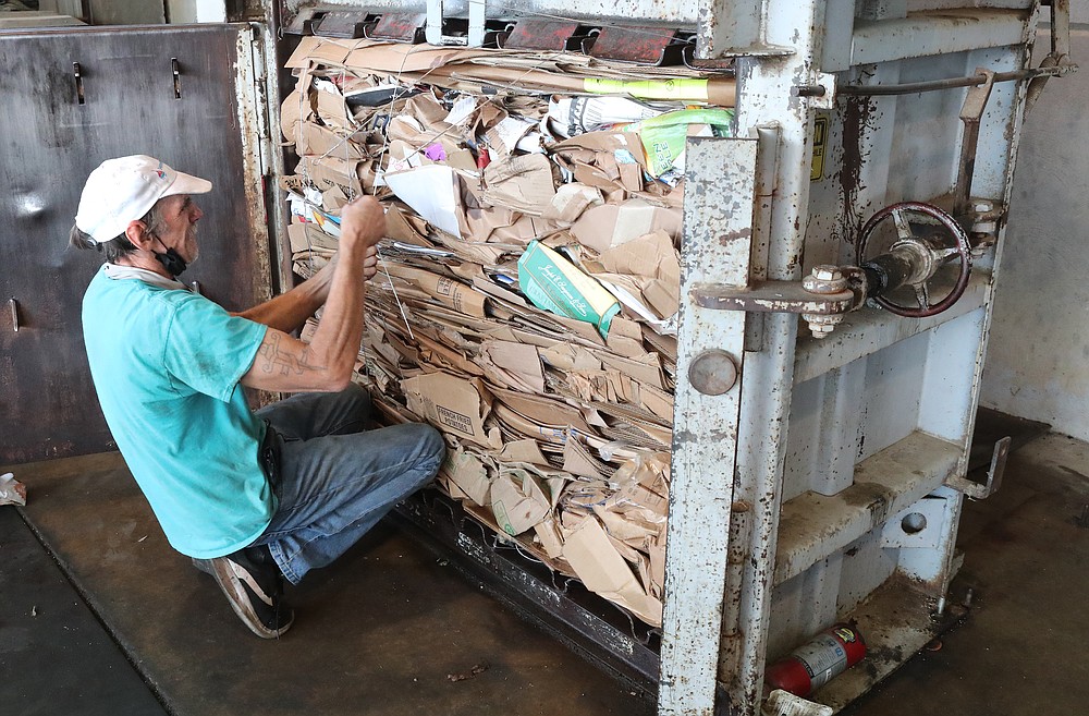 Cedar Glades Landfill employee William Shields bales cardboard Tuesday at the landfill. - Photo by Richard Rasmussen of The Sentinel-Record