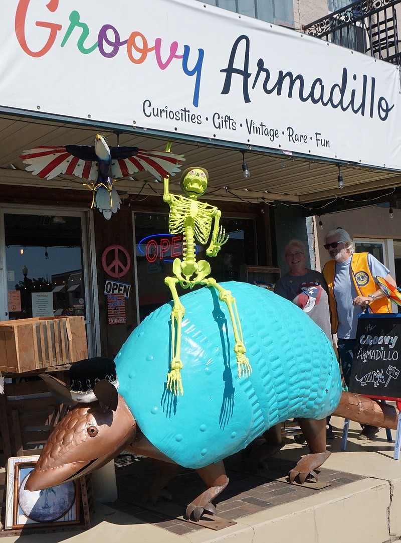 Groovy the armadillo in Linden certainly is getting into the Halloween spirit at his location on the town square. He’s giving rides to everyone who can hold on. Mr. Bones thinks he can do it. Groovy’s owners are Janelle and Lucky Boyd just under the awning at right. Groovy seems to have been welcomed and made to feel right at home. Perhaps that’s because the store’s name is giving him the compliment of being “groovy.”