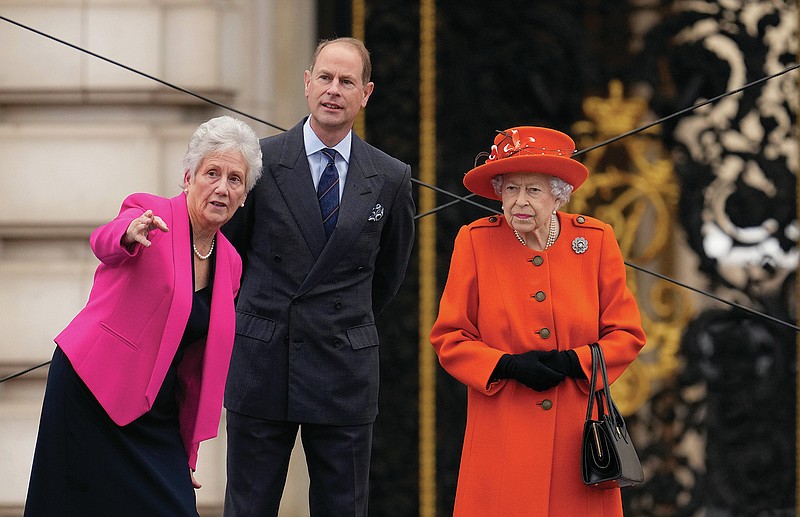 Britain's Queen Elizabeth II stands on stage with, from left, Dame Louise Martin the President of the Commonwealth Games Federation and Britain's Prince Edward during the Birmingham 2022 Commonwealth Games Queen's Baton Relay event outside Buckingham Palace in London, Thursday, Oct. 7, 2021. The city of Birmingham in England will host the 2022 Commonwealth Games. (AP Photo/Matt Dunham)