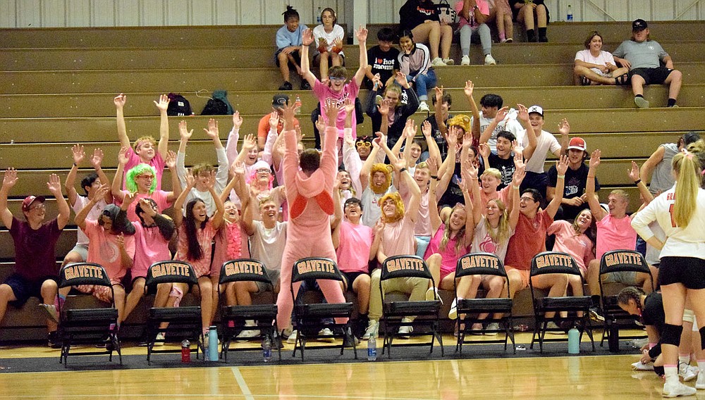 Westside Eagle Observer/MIKE ECKELS
The Gravette student secton, lead by, a pink bunny (center,) raises its hand straight up in roller coaster fashion during the Gravette-Gentry varsity volleyball match at the Competition Gym in Gravette Thursday night. In the final home game of the volleyball season, it was pink night and almost the entire student section wore some form of the color.