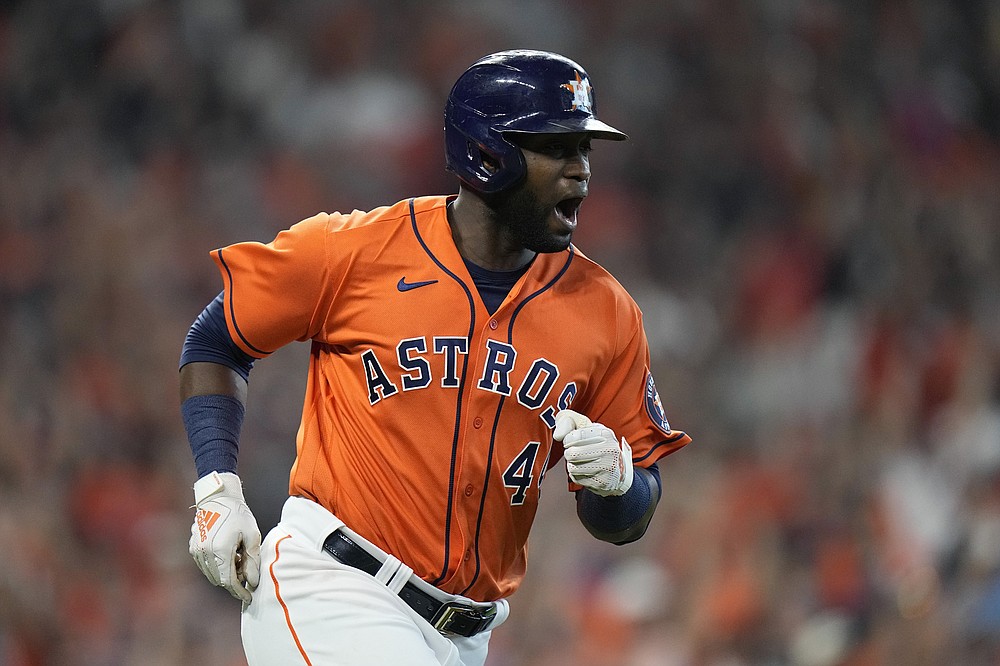 Houston Astros designated hitter Yordan Alvarez, left, celebrates a single against the Chicago White Sox during the seventh inning in Game 2 of a baseball American League Division Series Friday, Oct. 8, 2021, in Houston. (AP Photo/David J. Phillip)