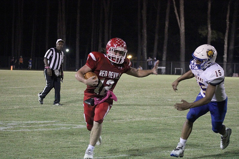 Mountain Pine’s Brice Langley (12) runs the ball as Spring Hill’s TJ Tipton moves in for a tackle in Friday’s game at Stanley May Field. - Photo by James Leigh of The Sentinel-Record