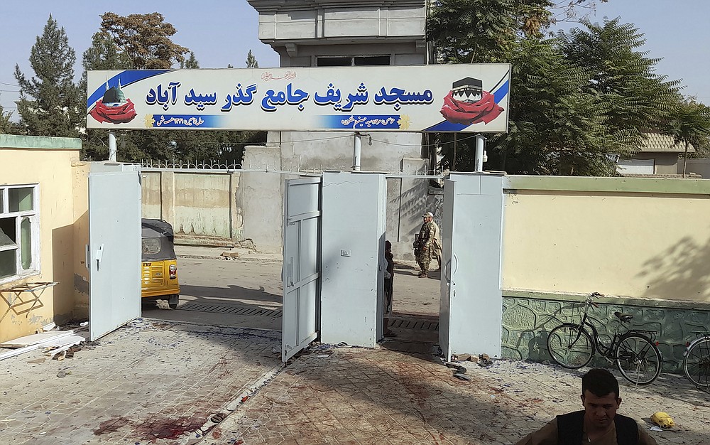 A blood-stained are seen outside a mosque following a bombing in Kunduz province northern Afghanistan, Friday, Oct. 8, 2021. A powerful explosion in the mosque frequented by a Muslim religious minority in northern Afghanistan on Friday has left several casualties, witnesses and the Taliban's spokesman said. (AP Photo/Abdullah Sahil)