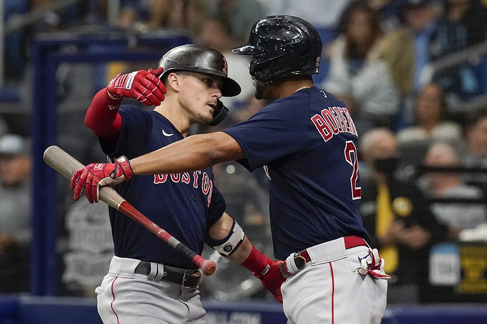 St. Petersburg, United States. 22nd June, 2021. Tampa Bay Rays catcher Mike  Zunino (L) looks on as Boston Red Sox's Rafael Devers hits a two-run double  during the 11th inning of a
