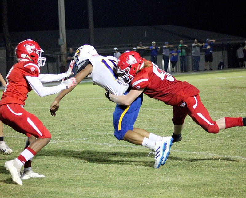 Mountain Pine's Toby Seymour (55) tackles Spring Hill's TJ Tipton (15) during a football game Friday, Oct. 8, 2021, at Mountain Pine. - Photo by James Leigh of The Sentinel-Record