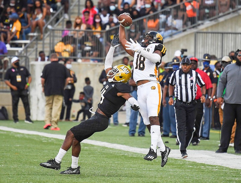 UAPB receiver Dalyn Hill catches a pass with one hand over Alabama State defensive back Jacquez Payton and runs the rest of the field for a 70-yard touchdown play in the fourth quarter Saturday in Montgomery, Ala. (Special to The Commercial/Brian Tannehill)