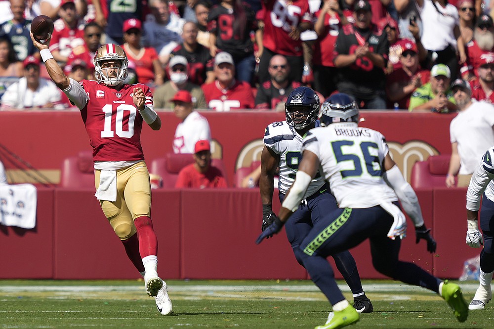 San Francisco 49ers quarterback Jimmy Garoppolo (10) passes against the Seattle Seahawks in the first half of an NFL football game in Santa Clara, Calif. On Sunday, October 3, 2021. (AP Photo / Tony Avelar)
