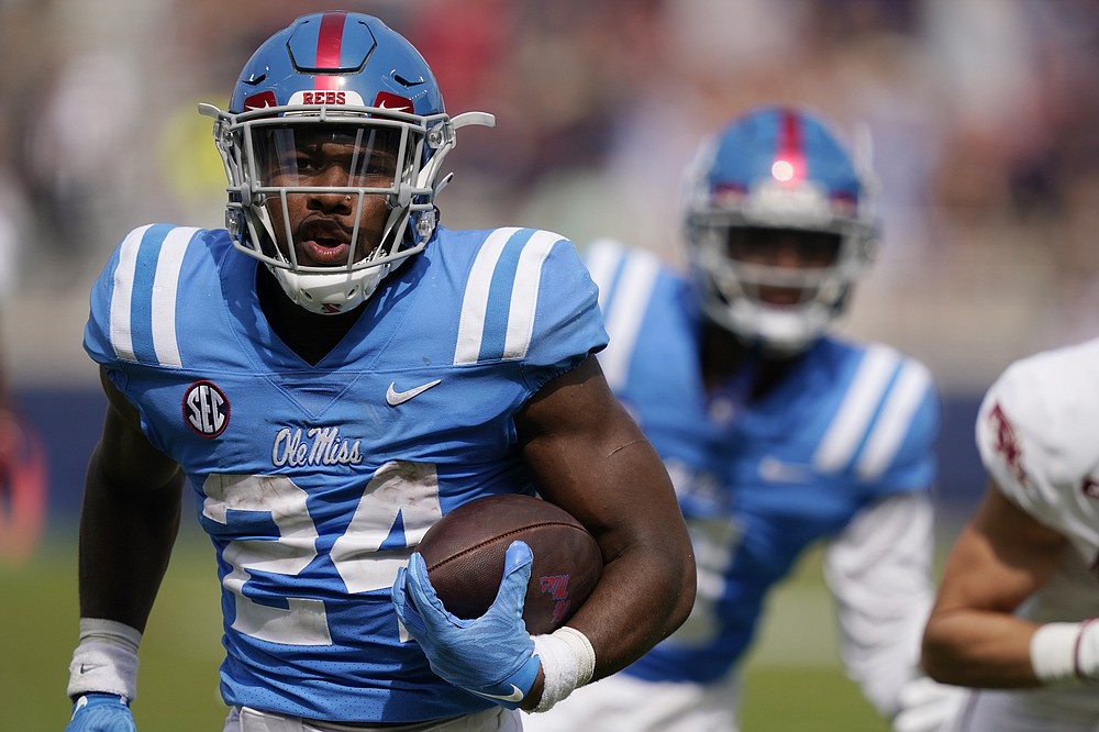 Mississippi running back Snoop Conner (24) rushes past a teammate on his way to a 34-yard touchdown run during the second half of an NCAA college football game, Saturday, Oct. 9, 2021, in Oxford, Miss. Mississippi won 52-51.(AP Photo/Rogelio V. Solis)
