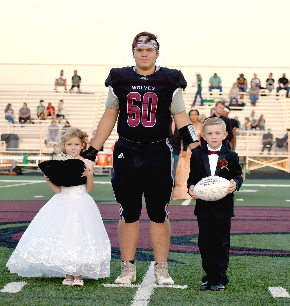 MARK HUMPHREY ENTERPRISE-LEADER/Lincoln Homecoming attendants, Bexlee Price (left) and Maverick Umberson, were escorted by senior Dakoda Christianson.