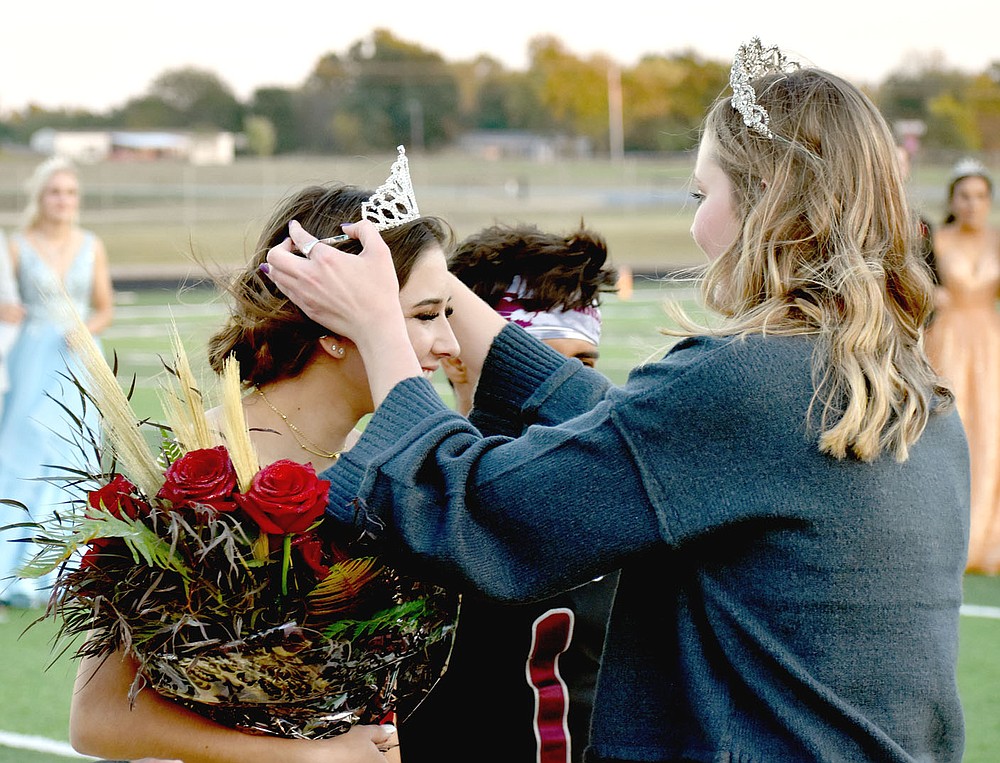 MARK HUMPHREY ENTERPRISE-LEADER/Lincoln senior Emily Meckley receives the 2021 Homecoming crown from 2020 Homecoming queen Keara Wallace, daughter of Shane Wallace and Jennifer Price.