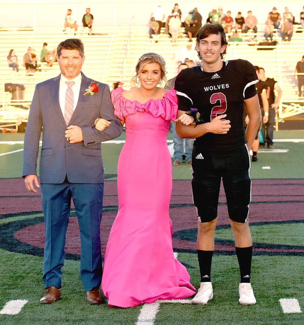 MARK HUMPHREY ENTERPRISE-LEADER/Lincoln freshman maid Brinkley Moreton, daughter of Dax and Christina Moreton, escorted by her father and sophomore Drew Moore, son of Joshua and Kendra Moore.