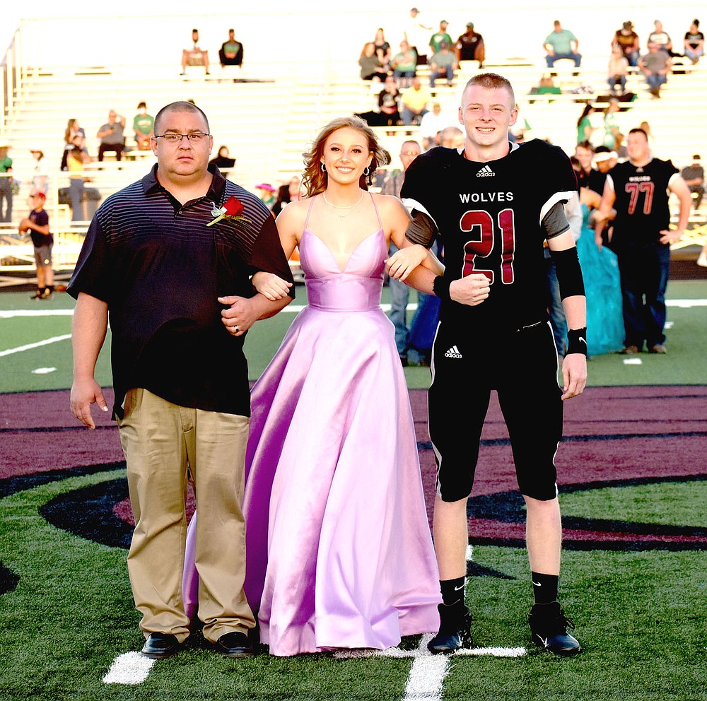 MARK HUMPHREY ENTERPRISE-LEADER/Lincoln junior maid Kate Hager escorted by her dad and senior Lincoln Morphis, son of Russell Morphis and Mandi Curry.