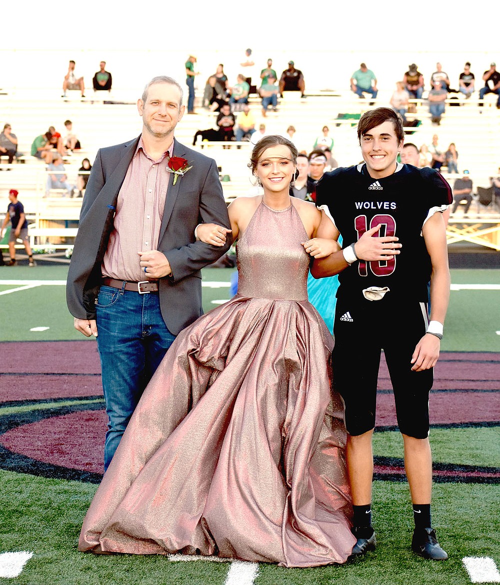 MARK HUMPHREY ENTERPRISE-LEADER/Lincoln junior Tabor Lewis escorted by her dad and senior Tristan Gilbreath.