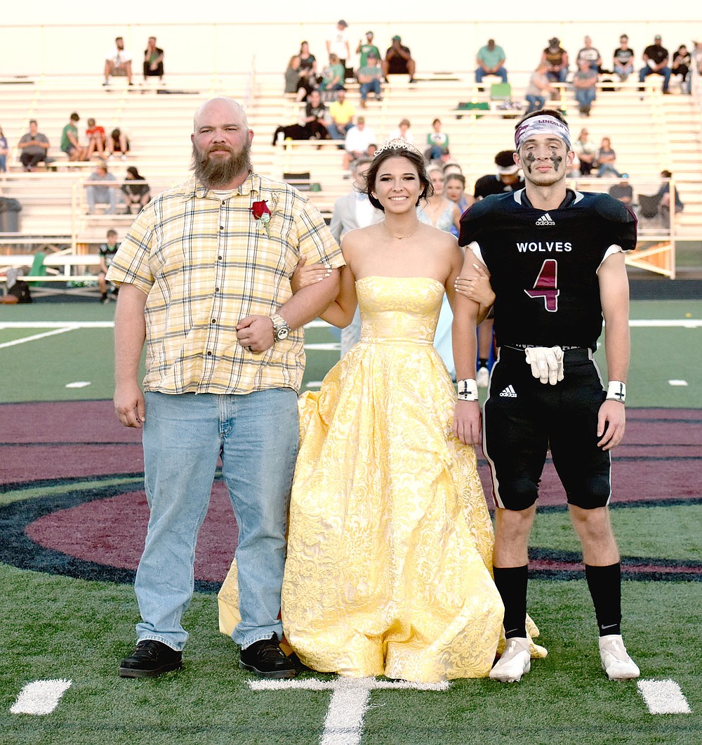 MARK HUMPHREY ENTERPRISE-LEADER/Lincoln senior maid Emily Meckley escorted by her father and senior Kyler Calvin.