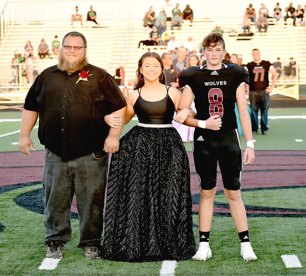 MARK HUMPHREY ENTERPRISE-LEADER/Lincoln sophomore maid Maura Tabor escorted by her dad and Gauge Davis.