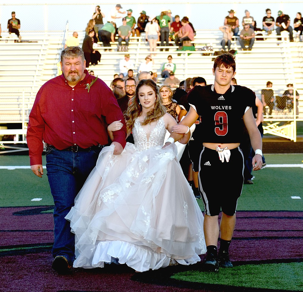 MARK HUMPHREY ENTERPRISE-LEADER/Lincoln sophomore maid Morgan Reeves escorted by her dad and sophomore Kellar Price.