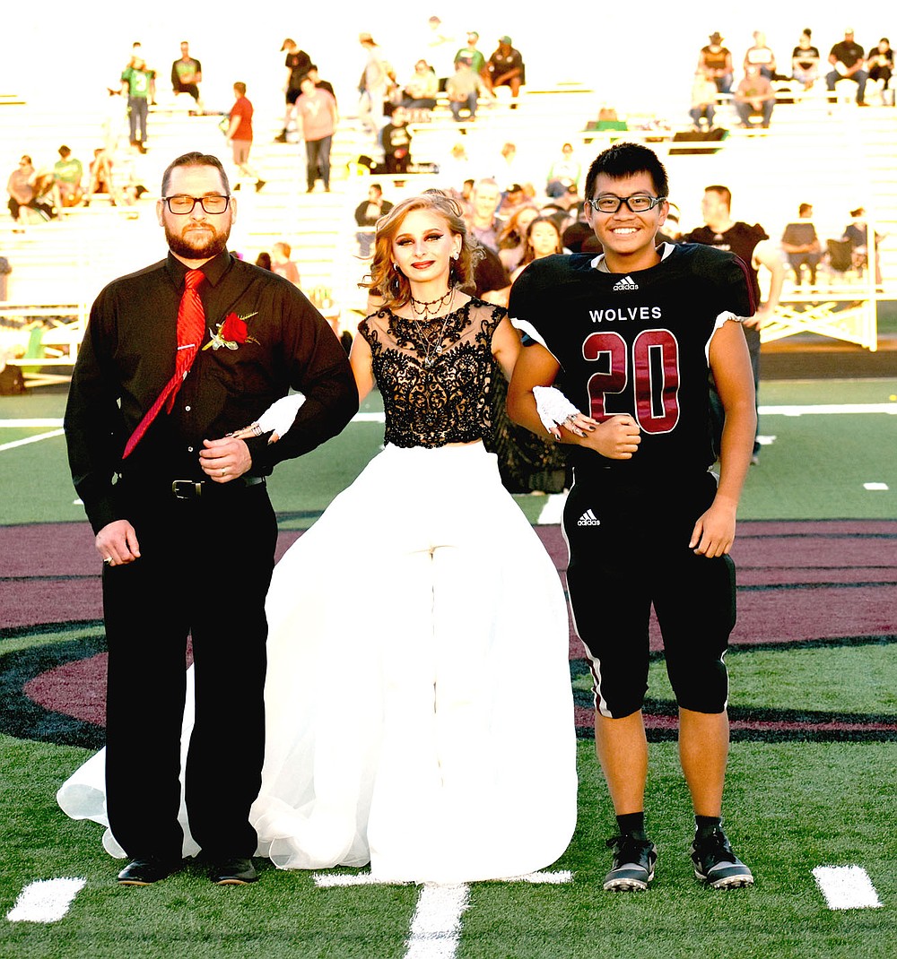 MARK HUMPHREY ENTERPRISE-LEADER/Lincoln sophomore Symphony Richards escorted by her dad and Nick Moua.