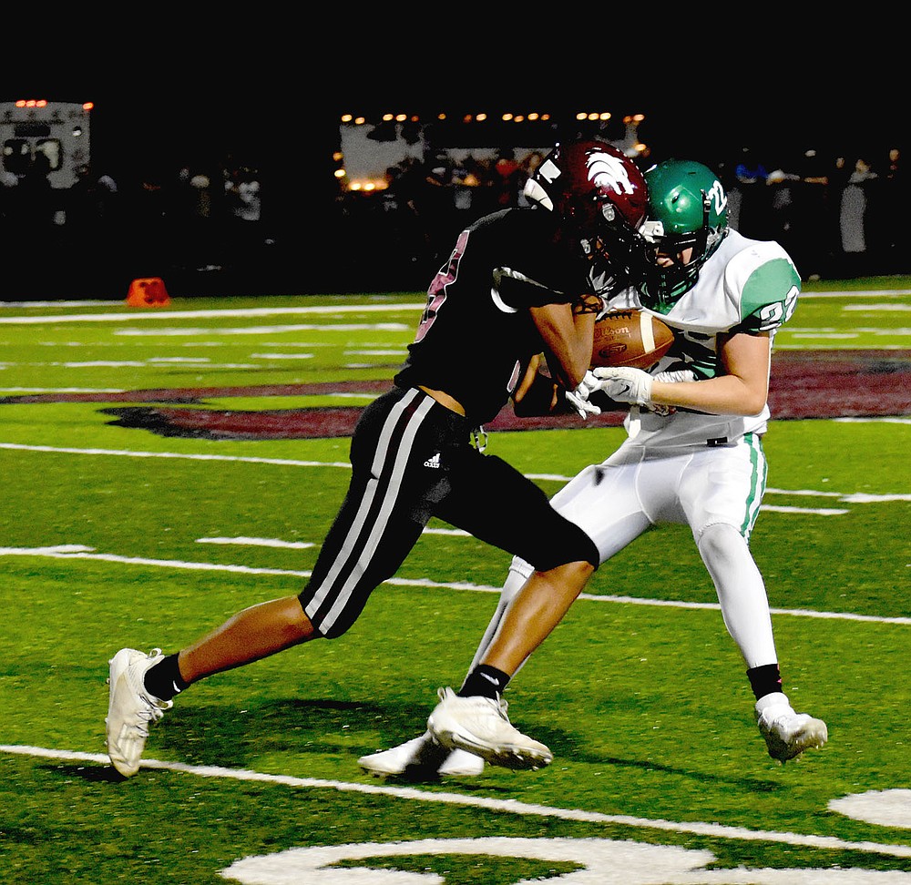 MARK HUMPHREY ENTERPRISE-LEADER/Lincoln senior wide receiver A.J. Garner nearly has a pass reception taken away as a Greenland defender tries to pull the ball out during the Wolves' 32-14 Homecoming win Friday.