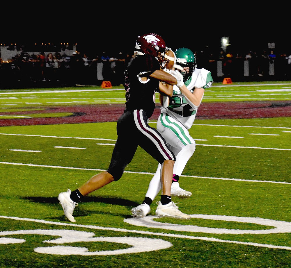 MARK HUMPHREY ENTERPRISE-LEADER/Not giving up the ball without a fight. Lincoln senior wide receiver A.J. Garner struggles to retain possession of the football after a pass reception was nearly ripped away by a Greenland defender during Lincoln's 32-14 Homecoming win Friday.