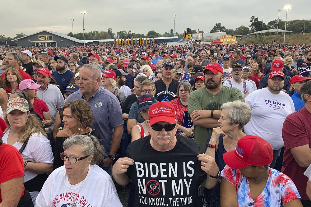 People gather ahead of an appearance by former President Donald Trump at a rally at the Iowa State Fairgrounds in Des Moines, Iowa., Saturday, Oct. 9, 2021. (AP Photo/Thomas Beaumont)