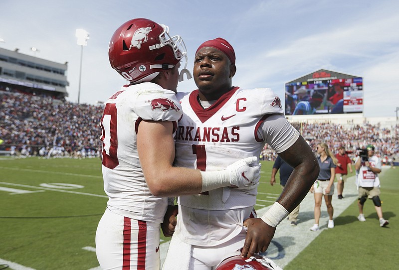 Arkansas linebacker Bumper Pool (10) consoles Arkansas quarterback KJ Jefferson (1) at the end of Saturday's football game at Vaught-Hemingway Stadium in Oxford, Miss. - Photo by Charlie Kaijo of NWA Democrat-Gazette