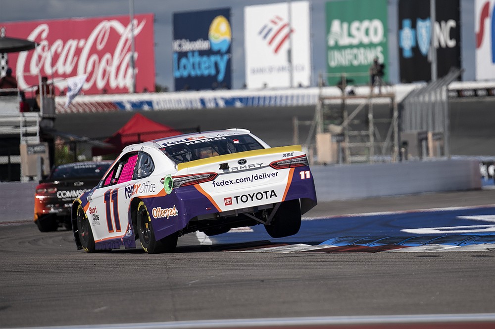 Denny Hamlin (11) drives during a NASCAR Cup Series auto racing race at Charlotte Motor Speedway, Sunday, Oct. 10, 2021, in Concord, N.C. (AP Photo/Matt Kelley)