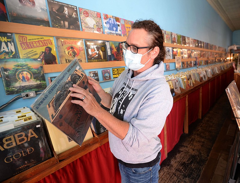 Wade Ogle, owner of Block Street Records, sorts through records Thursday, Oct. 7, 2021, at the longtime store in Fayetteville. Sales tax revenue for the Fayetteville topped $2.3 million in September. Go to nwaonline.com/211010Daily/ for today's photo gallery.
(NWA Democrat-Gazette/Andy Shupe)